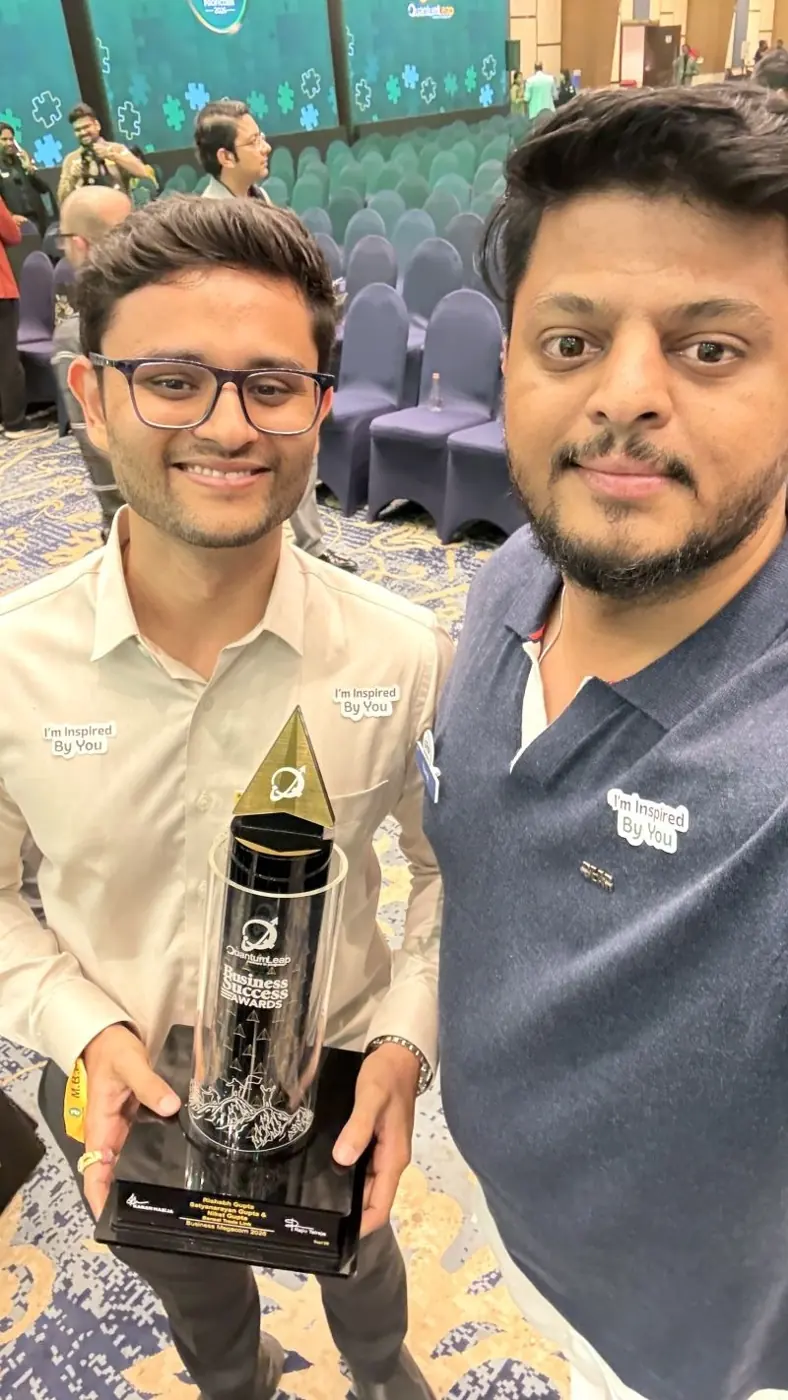Yuvraj with an award winner holding a Business Success Award trophy